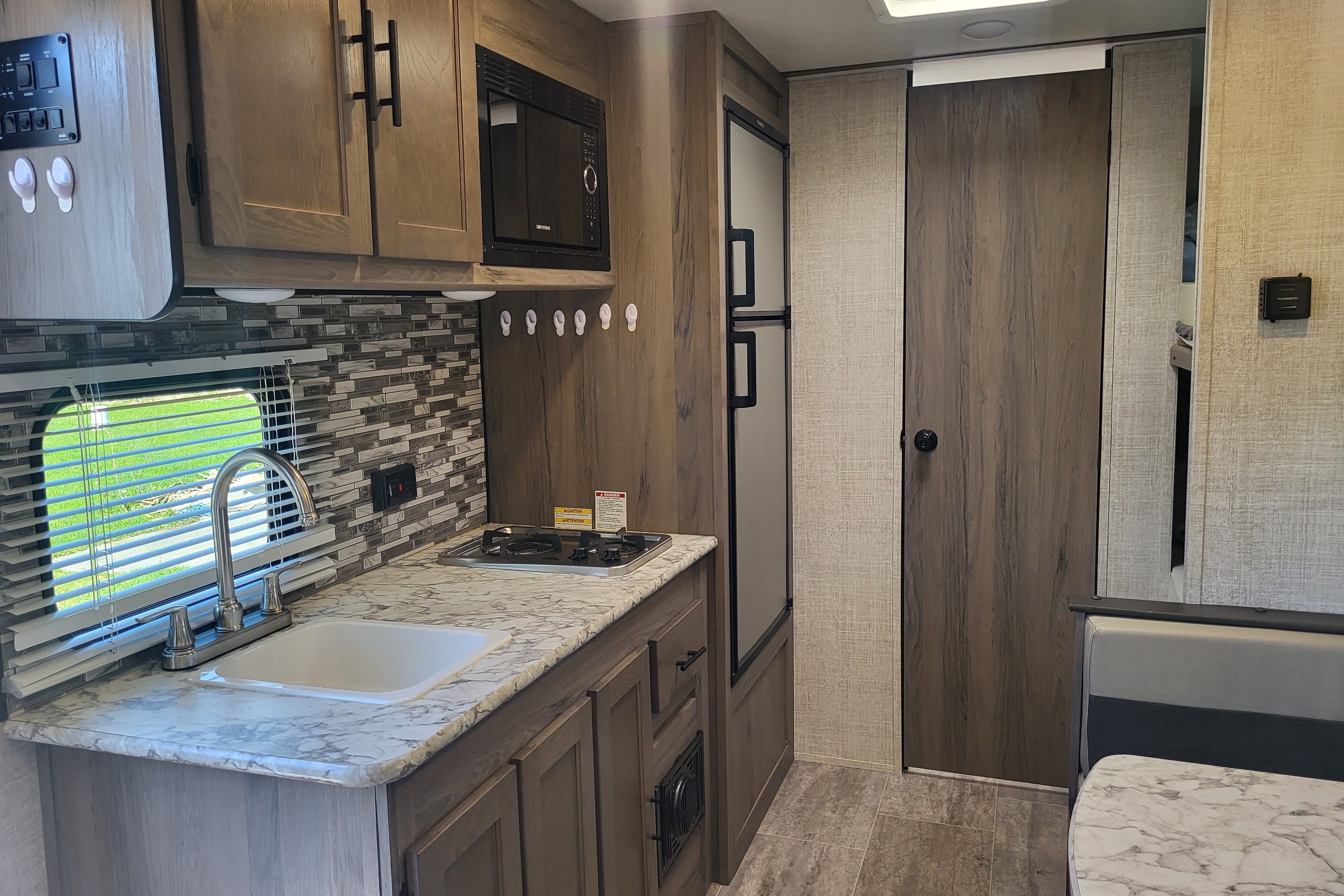 Venture in our Like New 2020 Grand River Bunkhouse Ultra-Lite Series Travel Trailer