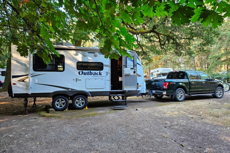 Experience Comfort and Adventure in our lightweight 2010 Keystone Outback with a king rear slide and bunk beds.