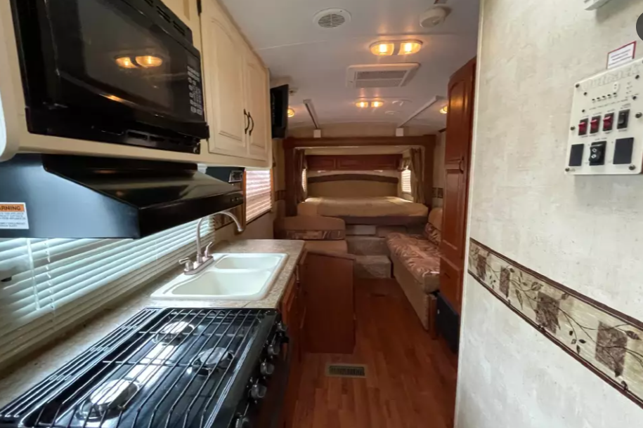 Experience Comfort and Adventure in our lightweight 2010 Keystone Outback with a king rear slide and bunk beds.