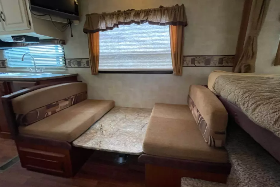 Experience Comfort and Adventure in our lightweight 2010 Keystone Outback with a king rear slide and bunk beds.