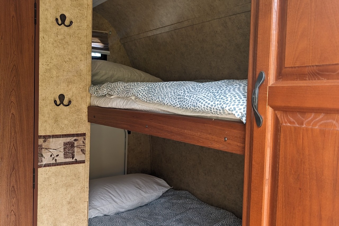 Experience Comfort and Adventure in our lightweight 2010 Keystone Outback with a king rear slide and bunk beds.