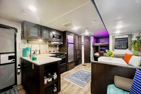 "Little home on wheels" 2020 WILDWOOD with master bedroom and bunks at the rear.