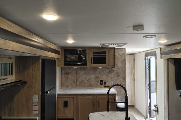 Matt and Shannon Forest River Alpha Wolf 26RL-L Travel Trailer